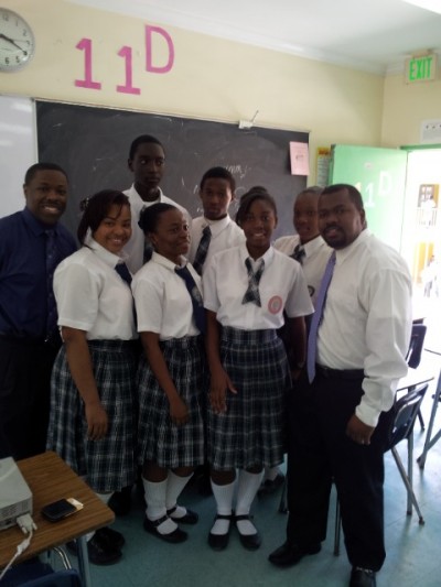 BISX CEO Keith Davies (far left) and Acting Chief Operating Officer Holland Grant (far right) along with students of Doris Johnson