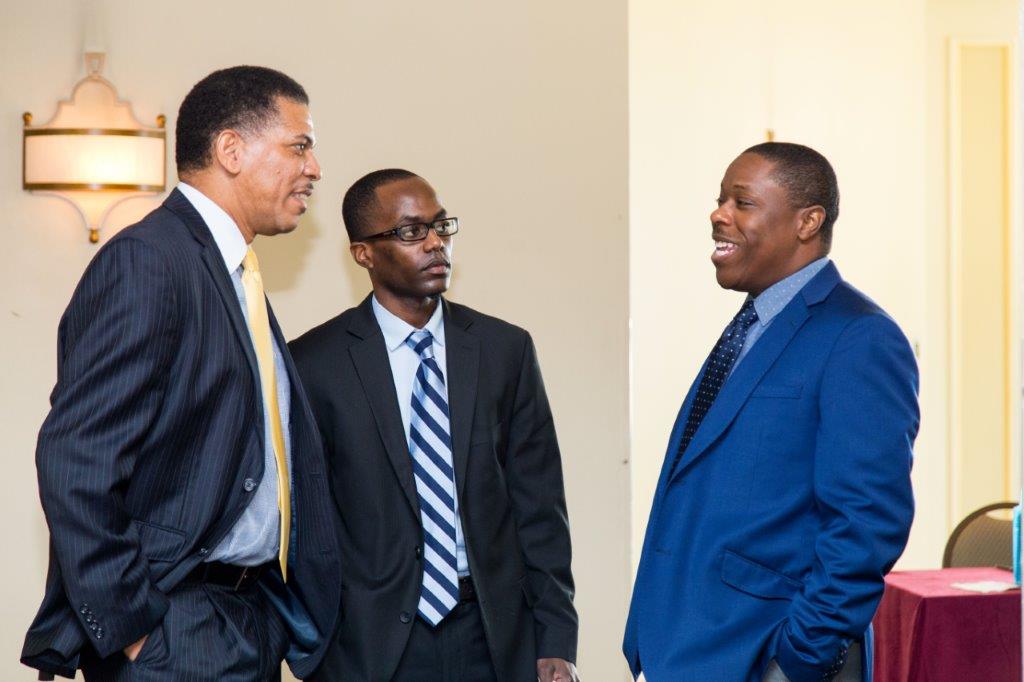From L to R: Famguard Corporation President Lyrone Burrows and Famguard VP Finance Ramon Curtis with BISX CEO Keith Davies