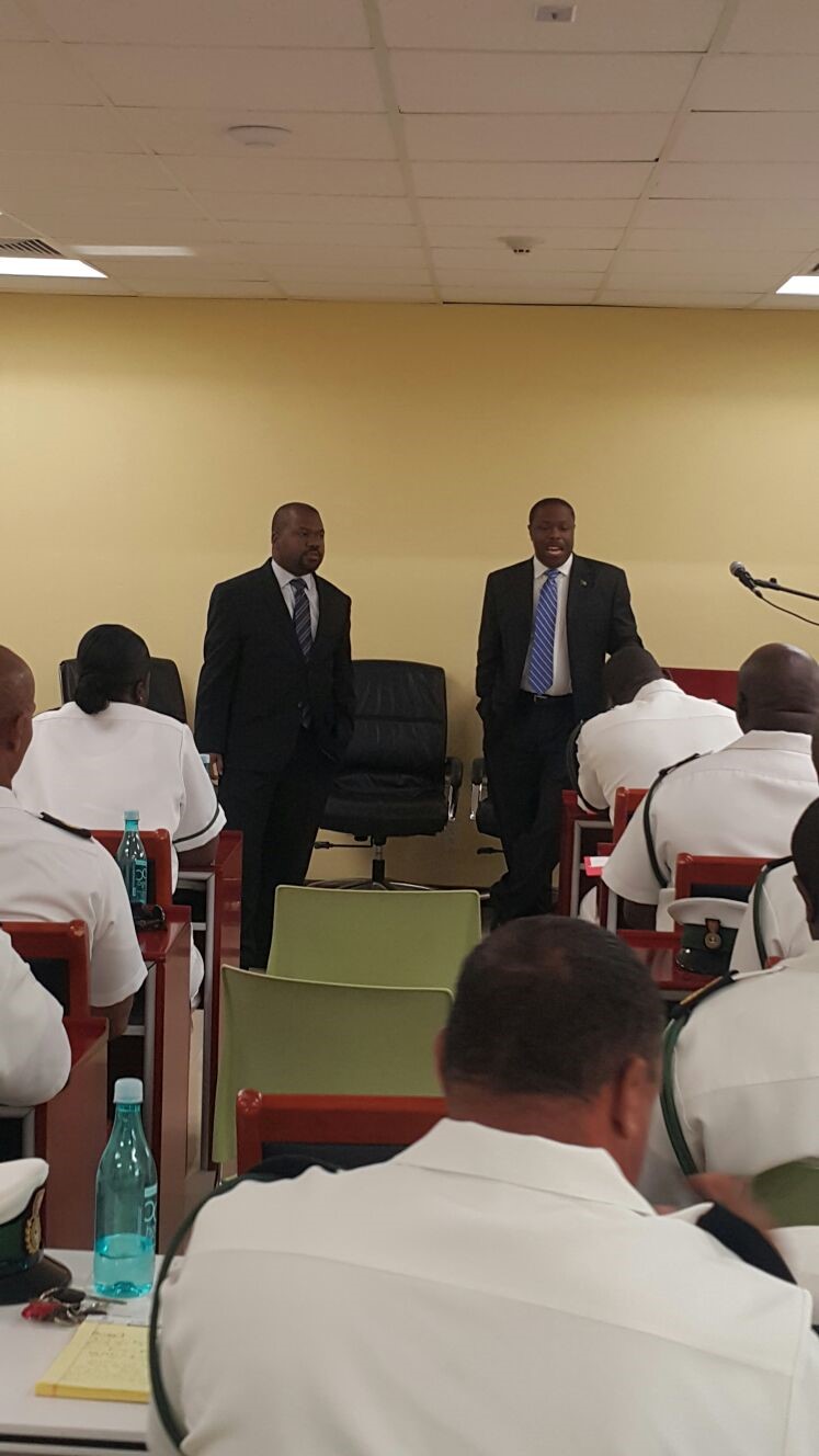 Top caption Left to Right BISX COO Holland Grant and CEO Keith Davies presenting to RBDF Officers